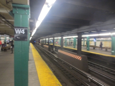 [New York]This is a picture of a typical station on the Subway. Rather austere often with 4 tracks unlike London's, two on the subsurface sections. Stations take the form of either two side platforms with no platforms on the centre tracks. At interchanges where people change on the same line between fast and slow trains the arrangement as shown is two island platforms.  Photo by Ian Brown for Railfuture