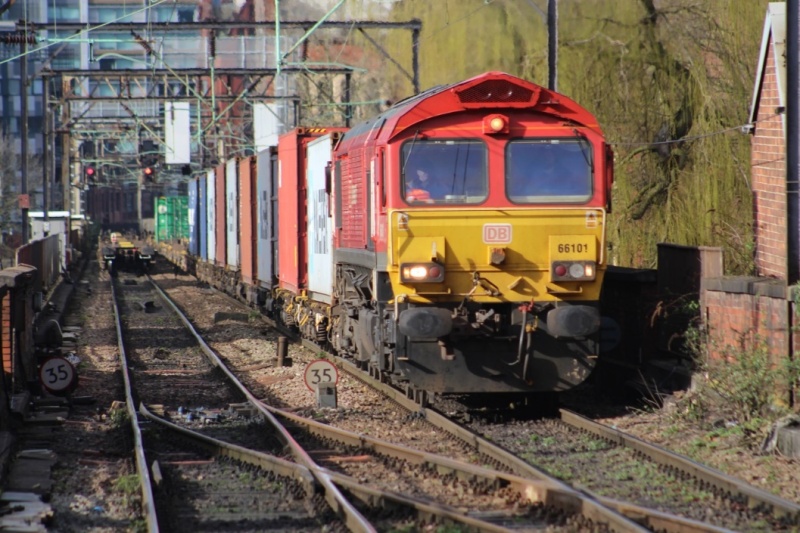 A Trafford Park to Southampton Western Docks freight train approaches Platform 13 at Manchester Piccadilly. To the left is the rear of a train to Trafford Park from London Gateway.  Photo by Phil Smart for Railfuture.